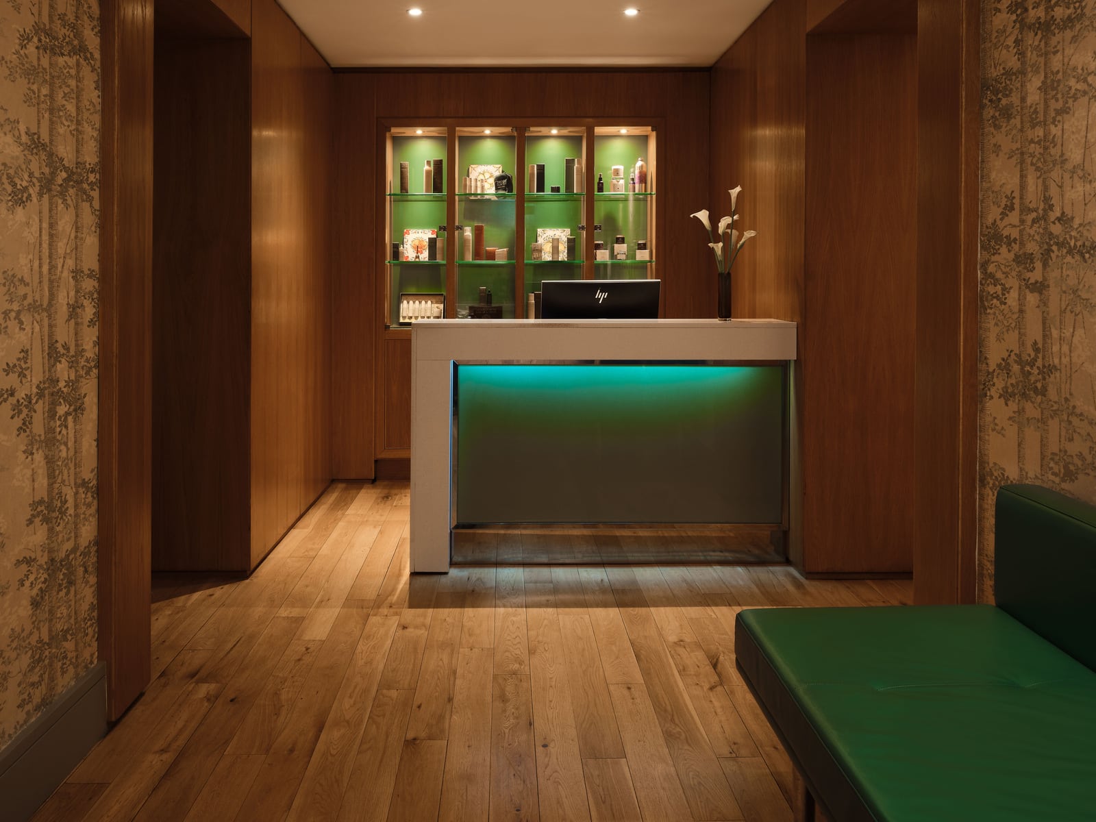 Spa reception desk with a lit skincare display case at Brown's Hotel, Mayfair