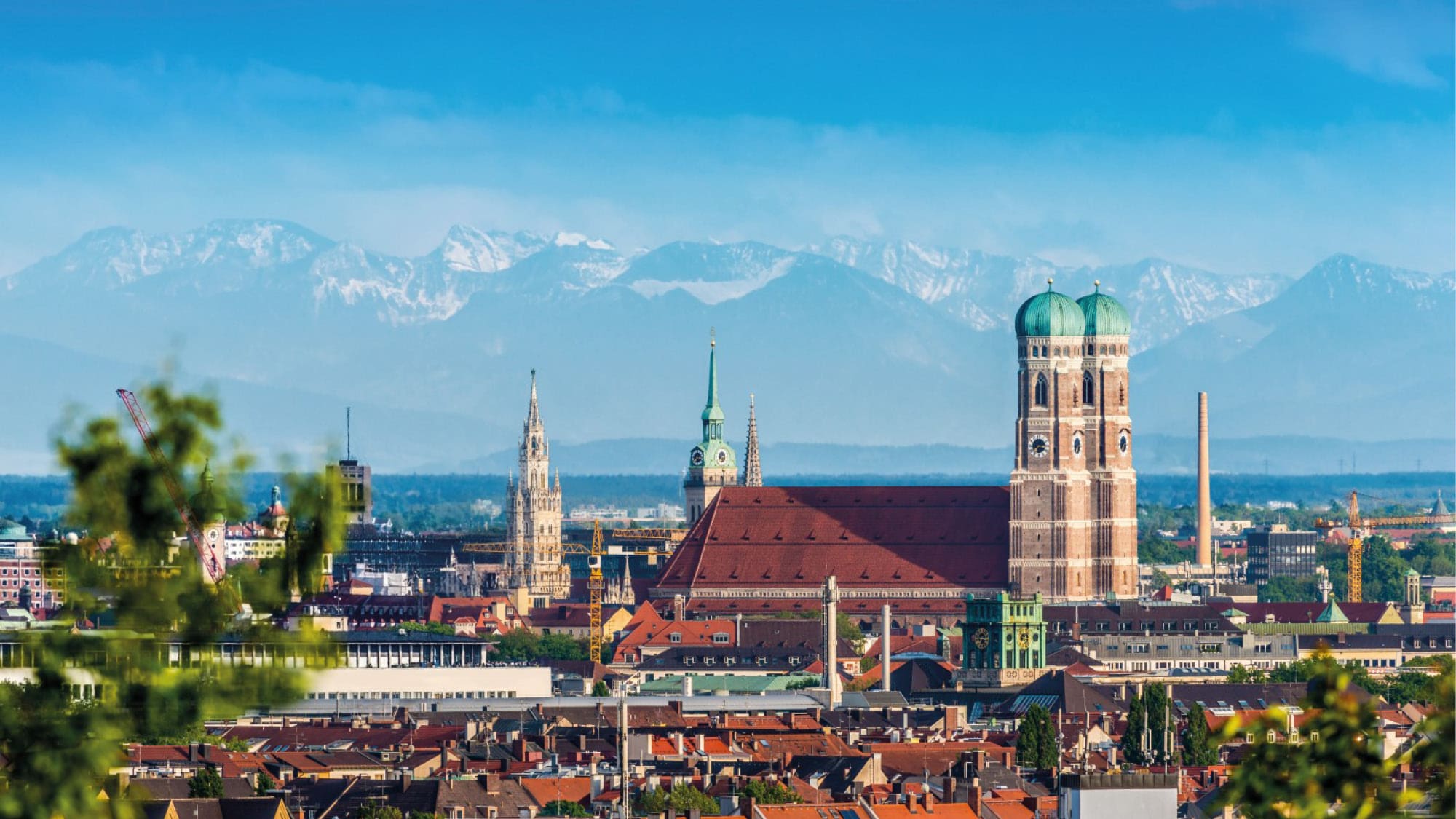 Stunning view over Munich with historical monuments and the alps in the background