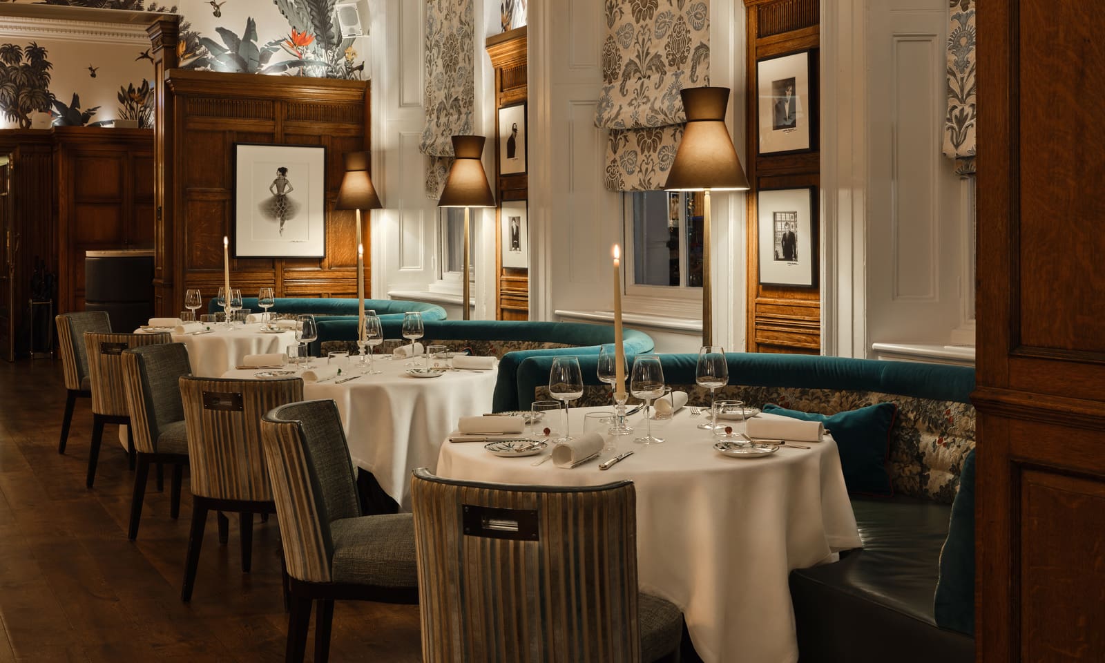 Candlelit dining room with teal velvet banquettes and wood panelling at Charlie's, Brown's Hotel, Mayfair